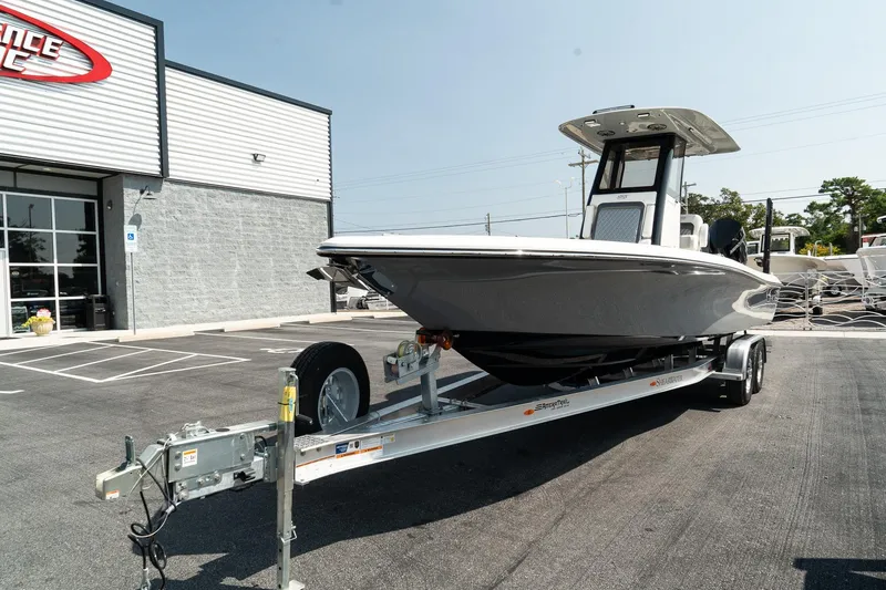 Slide: The Image of 2025 ShearWater 27 Carolina Open boat on trailer in parking lot. - 3