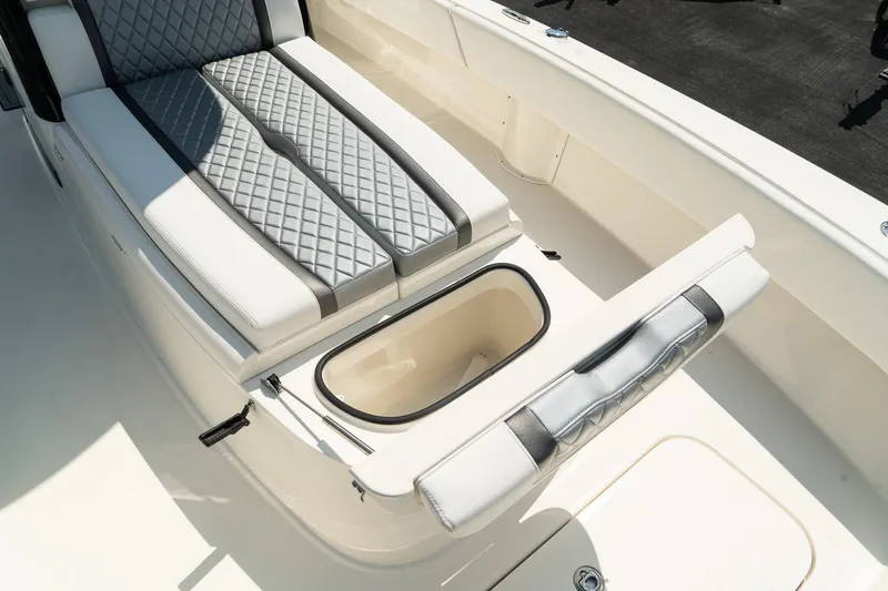 Slide: The Image of 2025 ShearWater 27 Carolina Open boat with cushioned seating and storage compartment. - 31