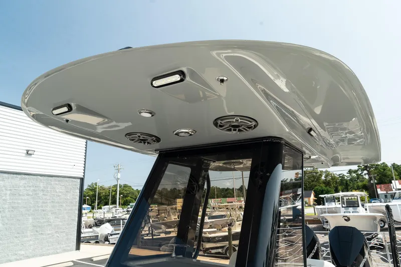 Slide: The Image of 2025 ShearWater 27 Carolina Open boat with sleek T-top and integrated speakers. - 34