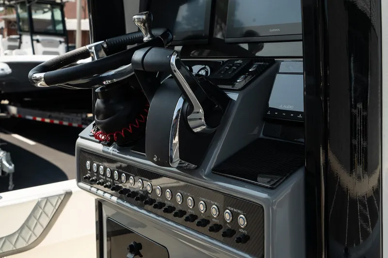 Slide: The Image of ShearWater 27 Carolina Open 2025 boat console with steering wheel and controls. - 37