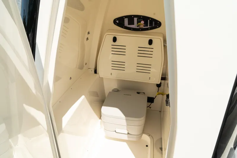 Slide: The Image of 2025 ShearWater 27 Carolina Open boat interior with compact marine toilet. - 38