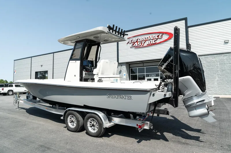 Slide: The Image of 2025 ShearWater 27 Carolina Open boat on trailer outside dealership. - 4