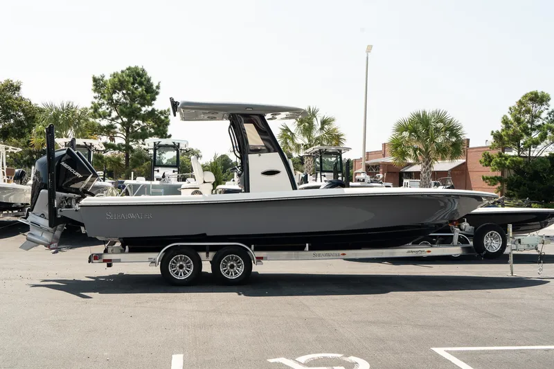 Slide: The Image of 2025 ShearWater 27 Carolina Open boat on trailer, parked outdoors. - 7