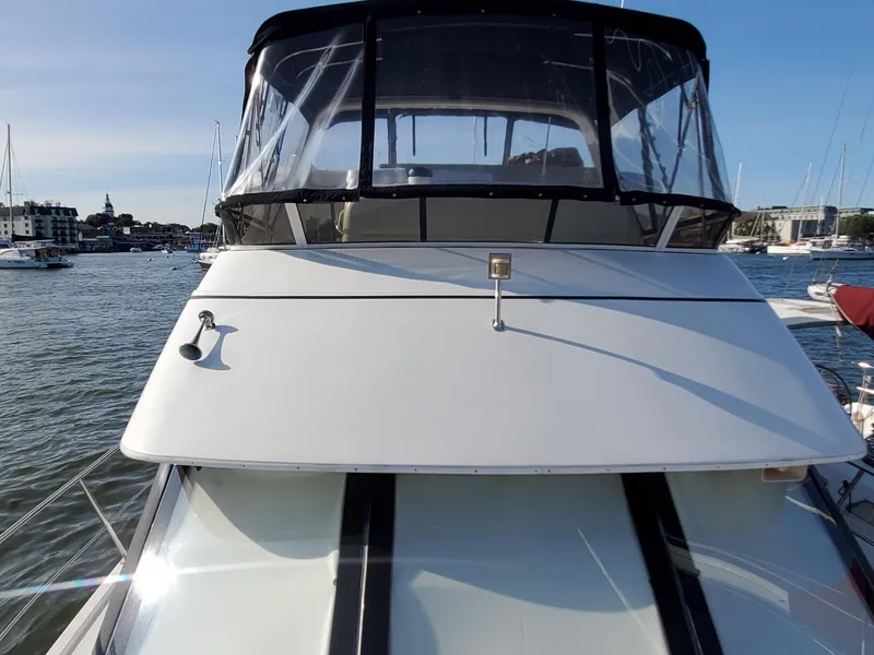 Slide: The Image of 2000 Carver 356 Aft Cabin Motor Yacht docked in a marina, front view. - 10