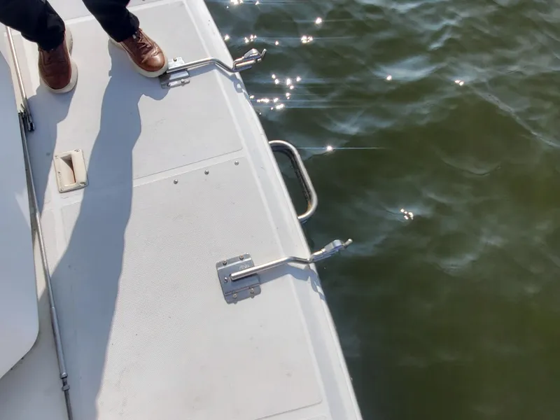 Slide: The Image of 2000 Carver 356 Aft Cabin Motor Yacht deck with water view and person standing. - 17