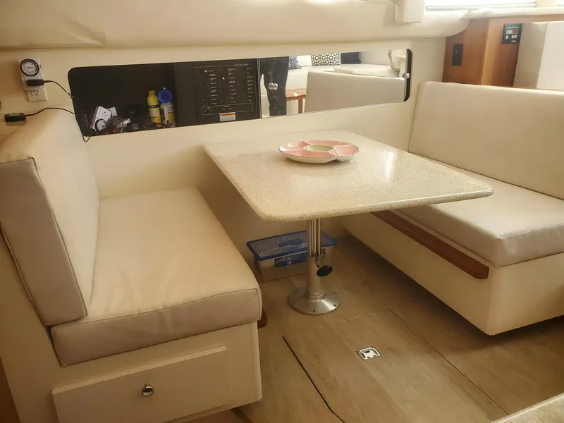 Slide: The Image of Interior of 2000 Carver 356 Aft Cabin Motor Yacht with dining area and cushioned seating. - 19