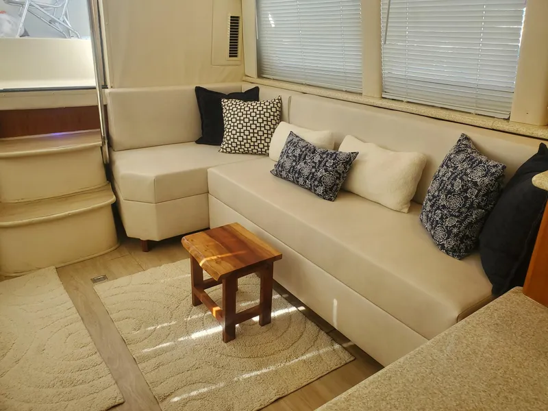 Slide: The Image of Interior of 2000 Carver 356 Aft Cabin Motor Yacht with beige seating and decorative pillows. - 21