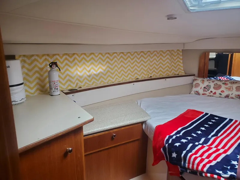 Slide: The Image of Interior of 2000 Carver 356 Aft Cabin Motor Yacht with cozy bed and storage. - 29