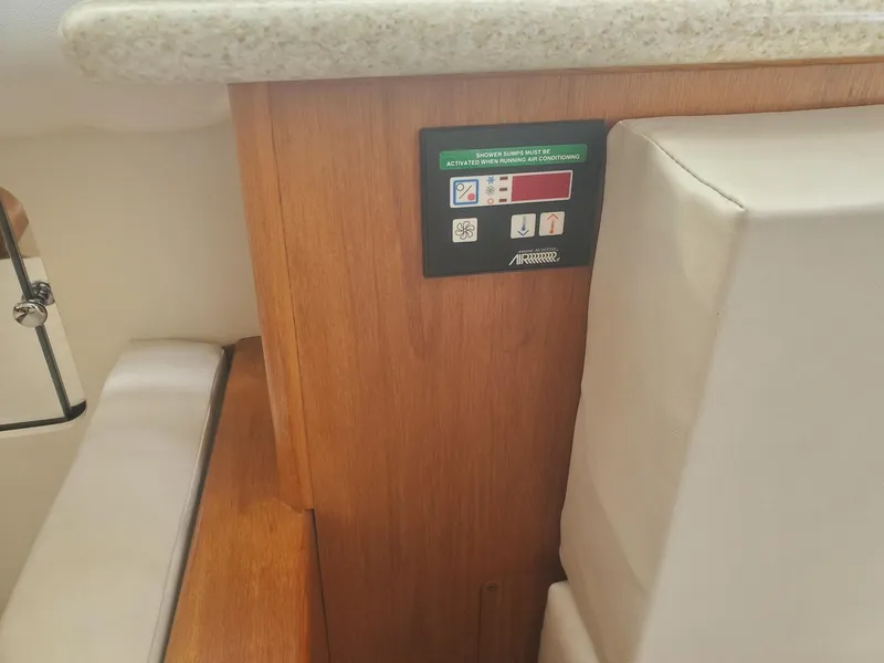 Slide: The Image of Control panel on 2000 Carver 356 Aft Cabin Motor Yacht interior, featuring wood and upholstery. - 30