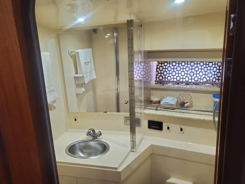 Slide: The Image of Bathroom interior of 2000 Carver 356 Aft Cabin Motor Yacht, featuring sink and mirror. - 31