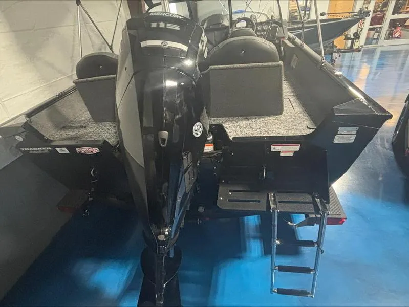Slide: The Image of 2025 Tracker PG V175 CB boat with outboard motor and ladder in showroom. - 10