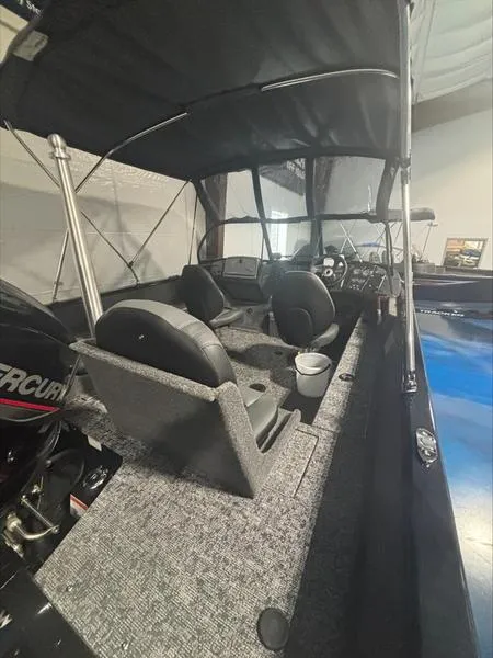 Slide: The Image of 2025 Tracker PG V175 CB boat interior with seating and canopy. - 11