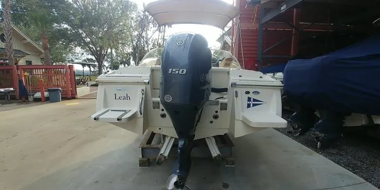 Slide: The Image of 2013 Scout 210 Dorado boat with Yamaha 150 engine, parked outdoors. - 12