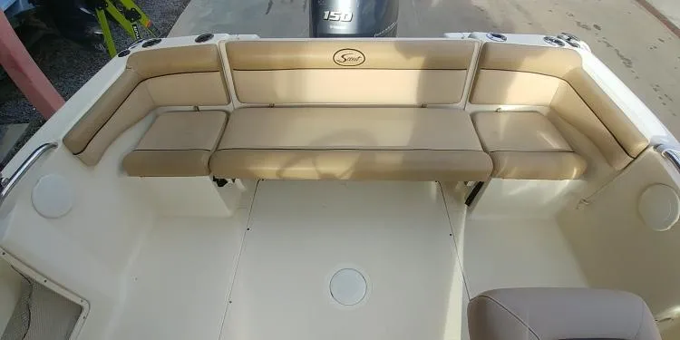 Slide: The Image of 2013 Scout 210 Dorado boat interior with beige seating and spacious layout. - 15