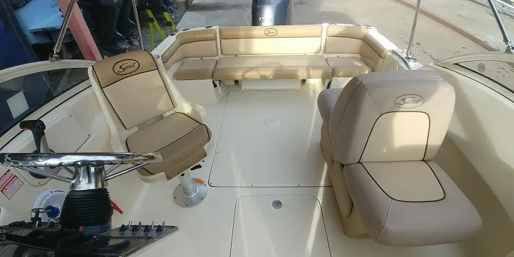 Slide: The Image of 2013 Scout 210 Dorado boat interior with beige seating and steering wheel. - 16