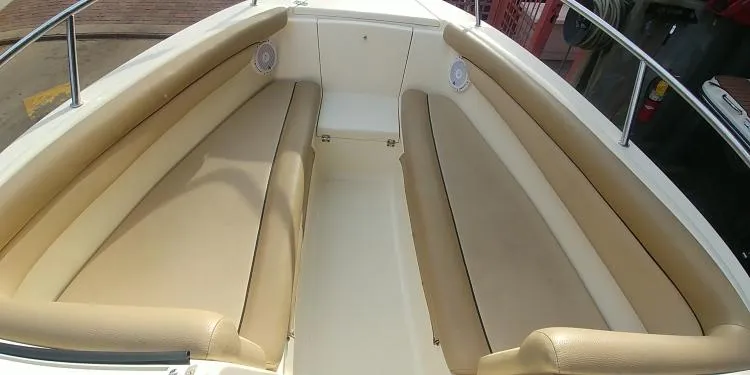 Slide: The Image of 2013 Scout 210 Dorado boat interior with beige seating and stainless steel railings. - 19