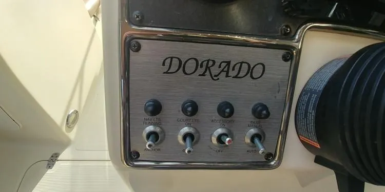 Slide: The Image of Control panel of a 2013 Scout 210 Dorado boat with labeled switches. - 21