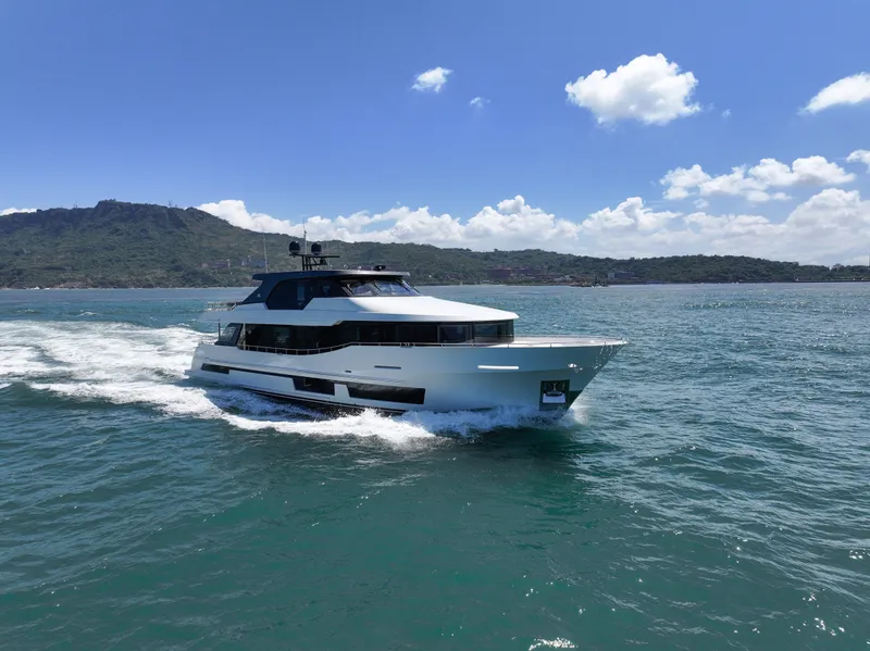 Slide: The Image of 2025 Ocean Alexander 28 Legend yacht cruising on open water. - 2