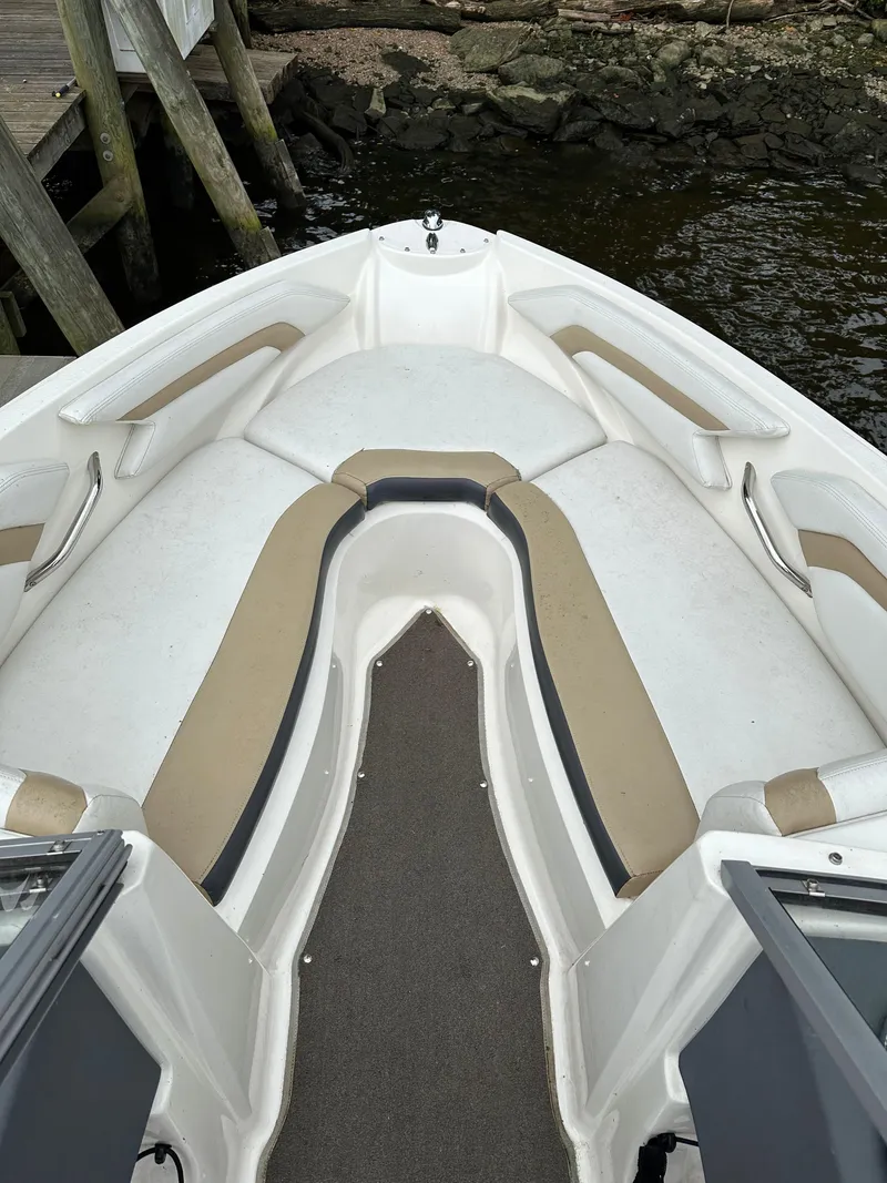 Slide: The Image of 2012 Chaparral 220 SSi boat interior with beige and white seating. - 12