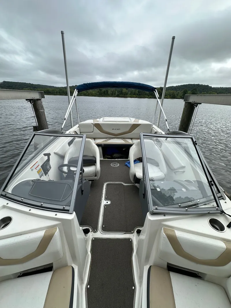 Slide: The Image of 2012 Chaparral 220 SSi boat on a lake with open cockpit and canopy. - 13
