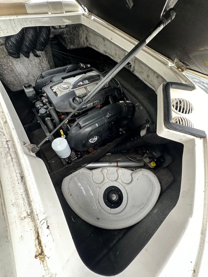 Slide: The Image of 2012 Chaparral 220 SSi boat engine compartment with visible components. - 15