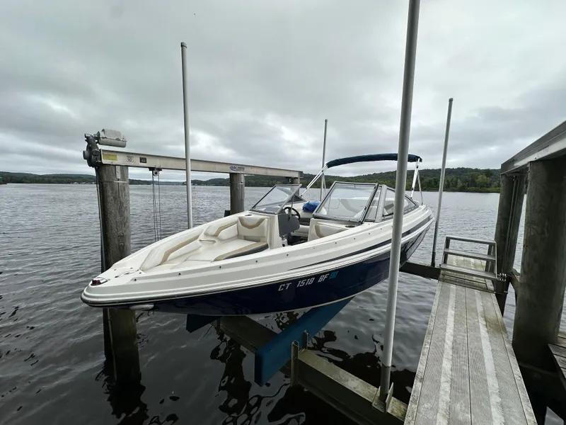 Slide: The Image of 2012 Chaparral 220 SSi boat on lift by lake dock. - 2