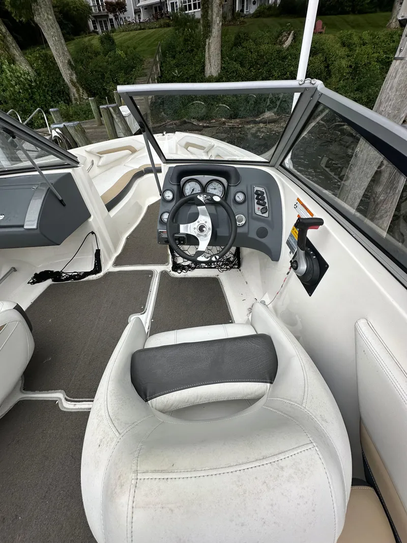 Slide: The Image of 2012 Chaparral 220 SSi boat interior with steering wheel and seating. - 7