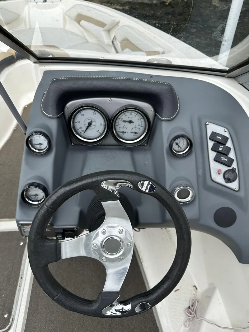 Slide: The Image of 2012 Chaparral 220 SSi boat dashboard with steering wheel and gauges. - 8