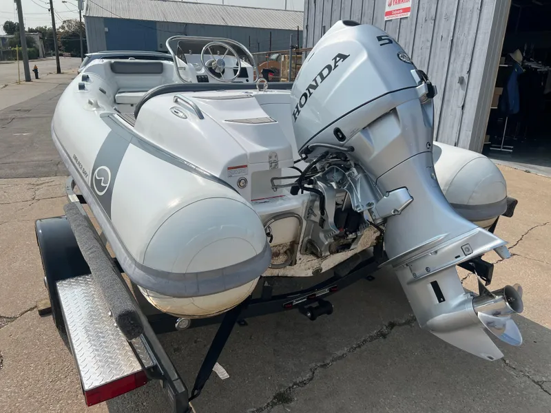 Slide: The Image of 2022 Walker Bay Generation 400 boat with Honda outboard motor on trailer. - 2