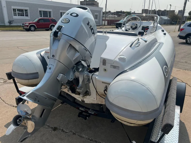 Slide: The Image of 2022 Walker Bay Generation 400 inflatable boat with Honda outboard motor on trailer. - 4