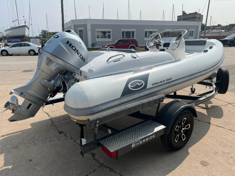 Slide: The Image of 2022 Walker Bay Generation 400 boat with Honda motor on a trailer. - 5