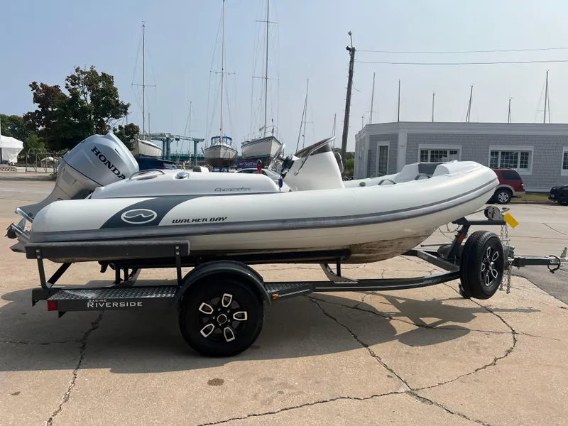 Slide: The Image of 2022 Walker Bay Generation 400 boat on trailer, parked in marina. - 6