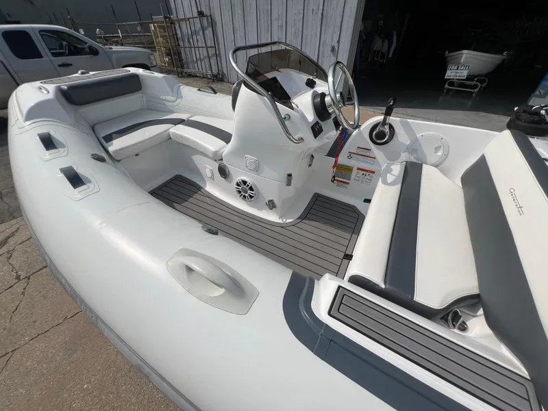 Slide: The Image of 2022 Walker Bay Generation 400 inflatable boat interior with steering console and seating. - 8