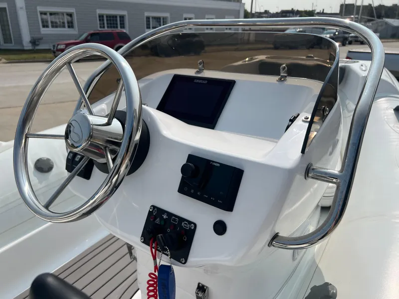 Slide: The Image of 2022 Walker Bay Generation 400 boat console with steering wheel and controls. - 9