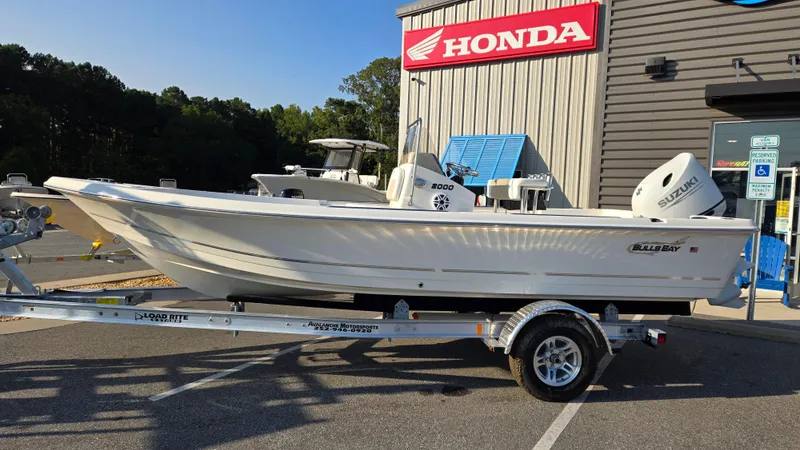 The Image of 2025 Bulls Bay 2000 boat on trailer, parked outside Honda dealership. - 1