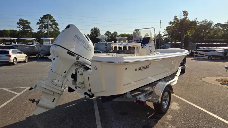 Slide: The Image of 2025 Bulls Bay 2000 boat with Suzuki outboard motor on a trailer in a parking lot. - 3