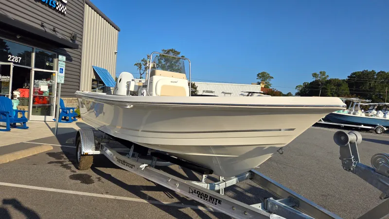 Slide: The Image of 2025 Bulls Bay 2000 boat on trailer outside dealership, sunny day. - 5