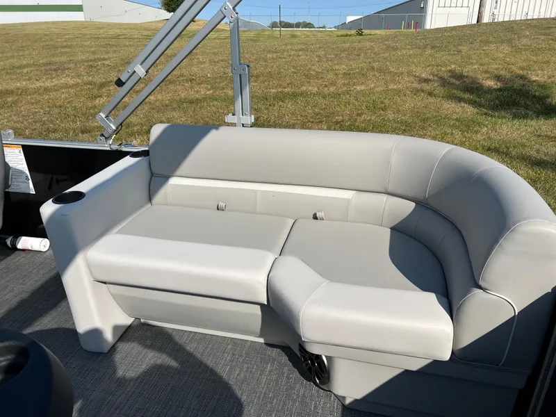 Slide: The Image of 2025 Godfrey Xperience 2286 SBX boat interior with gray seating and cup holder. - 16