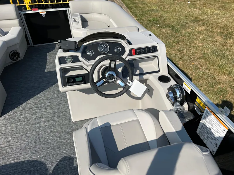 Slide: The Image of 2025 Godfrey Xperience 2286 SBX boat interior with steering wheel and seating. - 18
