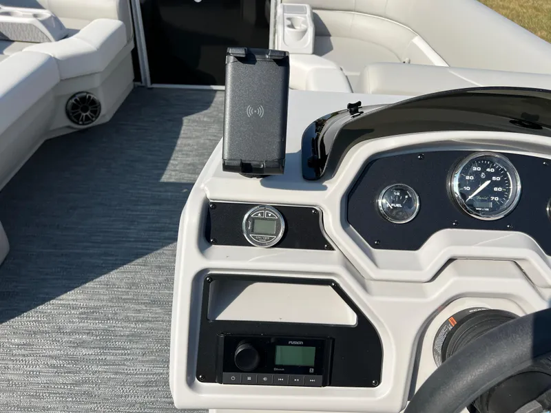 Slide: The Image of 2025 Godfrey Xperience 2286 SBX boat dashboard with modern controls and phone holder. - 20