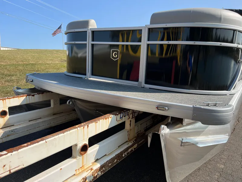 Slide: The Image of 2025 Godfrey Xperience 2286 SBX pontoon boat on a trailer, outdoors. - 6