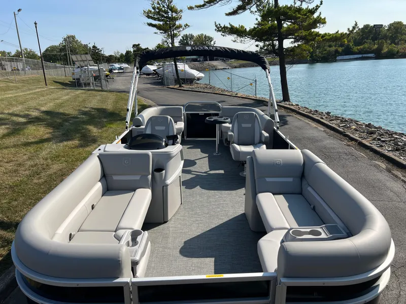 Slide: The Image of 2025 Godfrey Xperience 2286 SBX pontoon boat with spacious seating by a lakeside. - 7