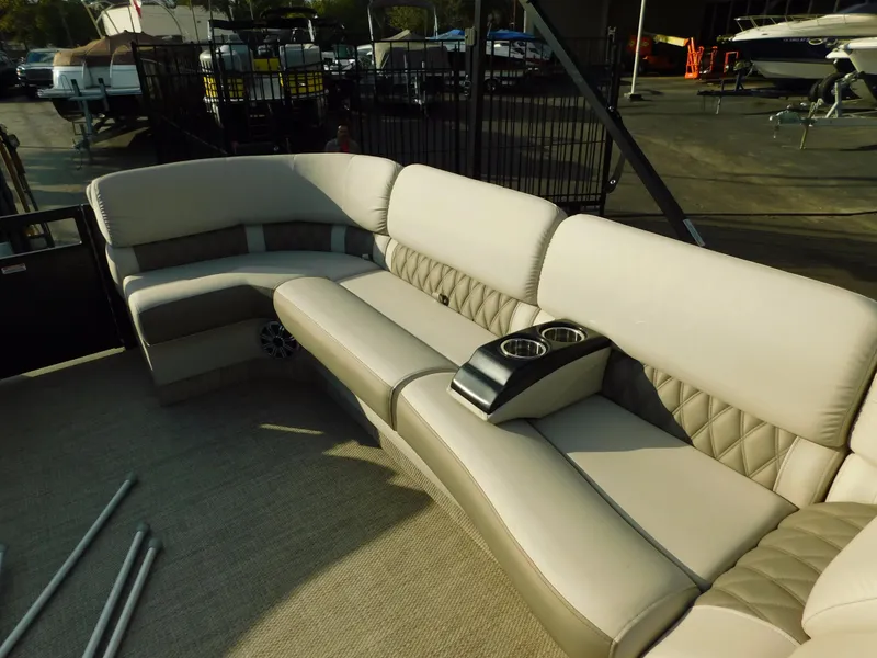Slide: The Image of Luxurious seating on 2018 Bennington 25 R boat with cup holders, docked at marina. - 10