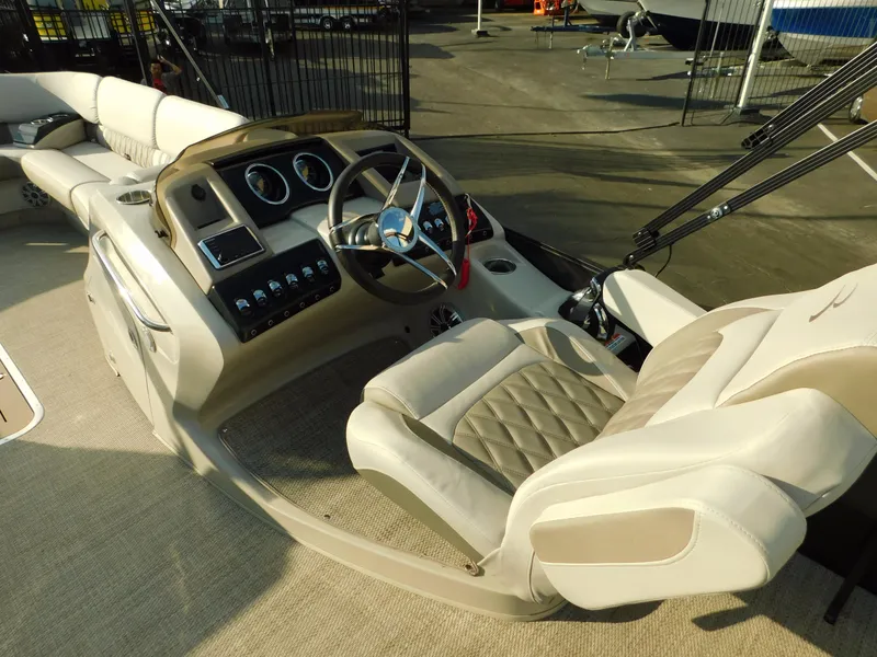 Slide: The Image of 2018 Bennington 25 R boat interior with steering wheel and plush seating. - 17