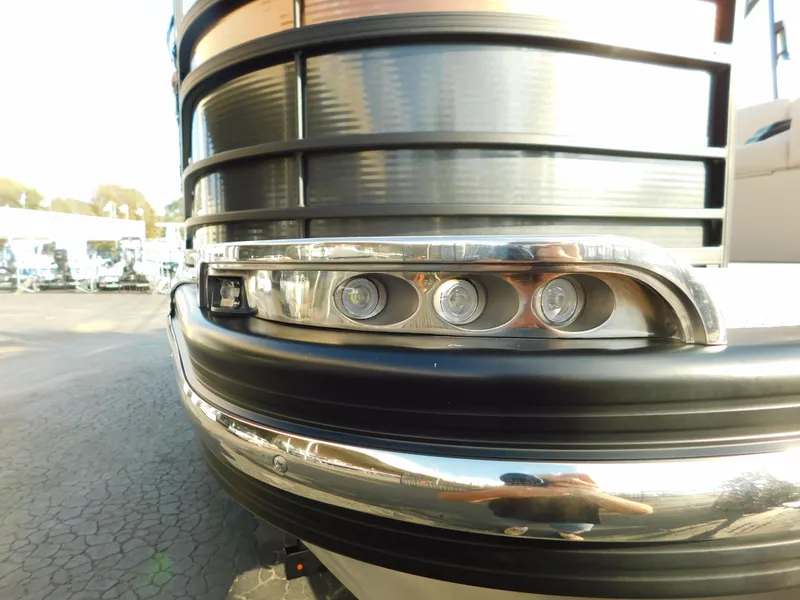 Slide: The Image of 2018 Bennington 25 R pontoon boat front detail with sleek design and modern lighting. - 2
