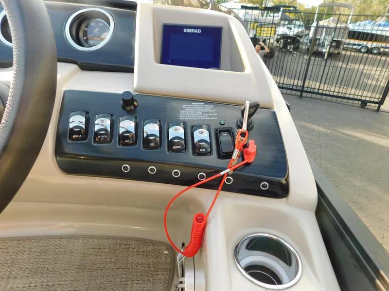 Slide: The Image of Control panel of a 2018 Bennington 25 R boat with switches and a Simrad display. - 20