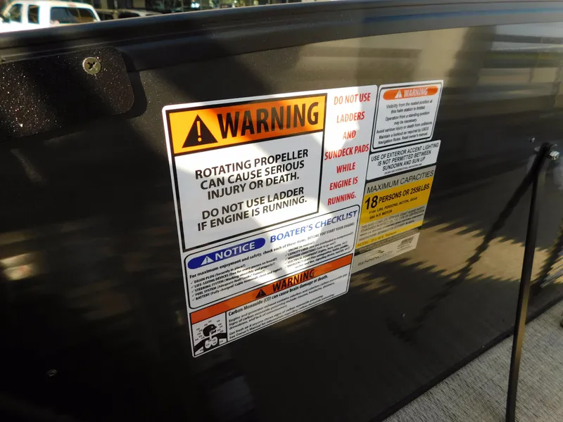 Slide: The Image of Warning labels on 2018 Bennington 25 R boat cautioning against propeller hazards. - 21