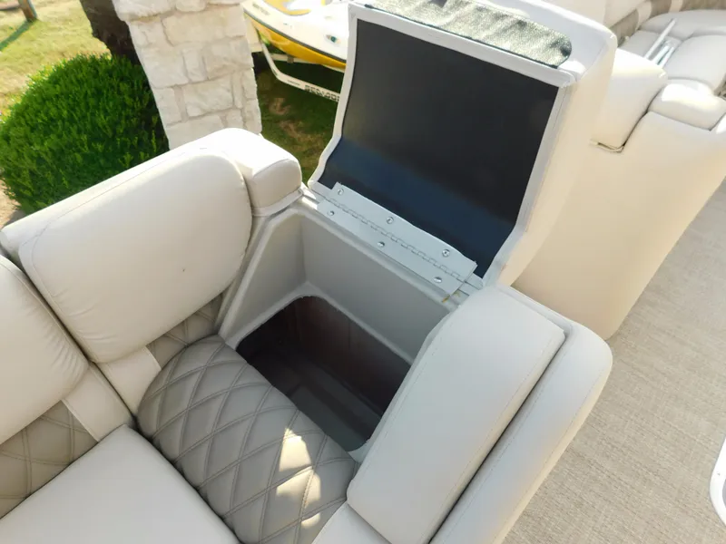 Slide: The Image of 2018 Bennington 25 R boat seat with open storage compartment, featuring quilted upholstery. - 25