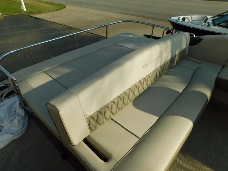 Slide: The Image of 2018 Bennington 25 R boat interior with beige seating and diamond-patterned upholstery. - 29