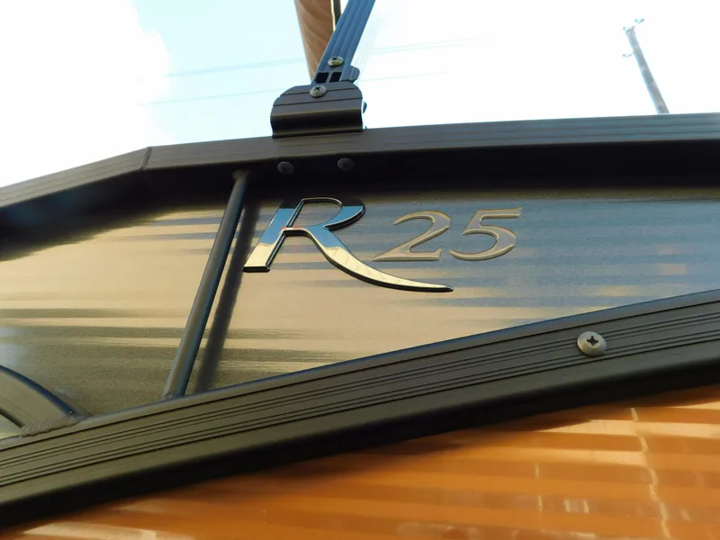 Slide: The Image of 2018 Bennington 25 R boat emblem close-up with sleek design. - 4